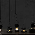 Five Black Hanging Teapots With Different Heating Devices Flames Charcoal Grey Wall And Wooden Floor