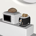 Modern Kitchen Appliances On White Counter With White Microwave Black Toaster And Bread