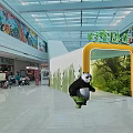 Panda in Mall Atrium With Yellow Archway Green Background And Colorful Murals