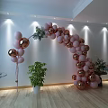 Pink And Gold Balloon Arch Decoration With Green Plants Wooden Floor White Walls And Lighting