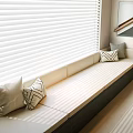 Elegant Light Colored Window Seat With Cushioned Surface Throw Pillows And Blinds