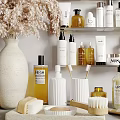 Modern Bathroom Accessories On Shelves With Towels And Dried Flowers