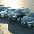 Various Modern Car Models In Lineup Along Sunlit Waterfront Area