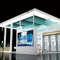 Modern Exhibition Booth Design With Glass Facade Reception Counter And Green Plants