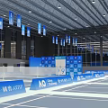 Indoor Sports Fitness Venue With Multiple Tennis Courts Blue Flooring Ceiling Lights And Side Banners