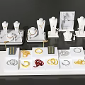 Elegant Jewelry Display With Gold Silver Red Rings Bracelets On White Trays