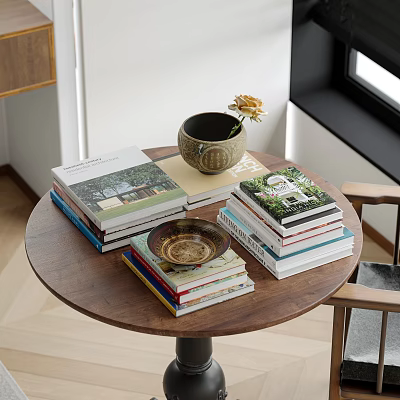 Stacked Books and Magazines on Wooden Table with Decorative Vase and Bowl 3d model