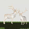 Two Geometric Metal Deer Sculptures As Art Installations On Grass With Light Colored Wall Background