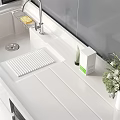 Bathroom Vanity Cabinet with Washing Machine White Countertop Sink Faucet Toiletries and Potted Plant