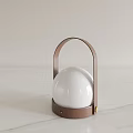 Modern Decorative Lamp With Brown Metal Handle And White Spherical Lampshade On Marble Countertop
