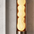 Modern Wall Sconces With Metal Frame And Glowing Irregular Shaped Globes On Gray Wall Interior
