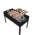 Black Metal Barbecue Grill with Charcoal and Meat Skewers on Wooden Handles