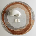 Round Rug With Circular Patterns Brown Gray Tones Featuring Polar Bear Figurine And Open Book