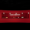 Tea Break Area Featuring Liquid Laboratory Sign Red Wall Counter And Bottles