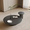 Modern Round Black Coffee Table With Sleek Design Topped With Book White Plate And Fruits