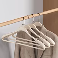 White Plastic Hangers On Wooden Rod For Hanging Clothes In Closet