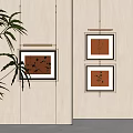 Minimalist Botanical Paintings Hanging On Beige Wall With Black Frames And Decorative Leaves