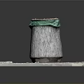 Concrete Trash Bin Setup With Green Trash Bag On Square Stone Slab