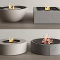 Modern Fireplaces In Concrete Shapes With Burning Flames And Black Pebbles
