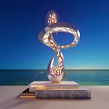 Silver Curved Sculpture With Hollowed Light Spots Illuminated By Seaside Blue Sky And Sea