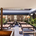 Modern Restaurant Outdoor Courtyard With Green Plants Water Feature And Wooden Tables