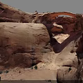 Natural Red Sandstone Rock Arch With Surrounding Desert Vegetation And Landscape