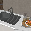 Black Modern Kitchen Sink on White Countertop with Fruit Bowl Olive Plant and Oil Bottles