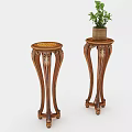 Two Wooden Plant Stands with Carved Legs and Potted Green Plant