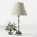 Ivory Lampshade Table Lamp with Glass Globe Base and Green Plant against White Wall Paneling