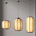 Modern Three Pendant Lights With Warm Toned Cylindrical Shades And Metal Frames