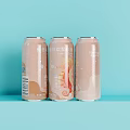 Three Light Brown Beverage Cans With Creative Design On Light Blue Background