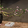 Ceramic Jar With Pink Flowers Branch On Wooden Table Beside Books And Scattered Petals