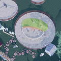 Circular Outdoor Recreational Space With Green Lawn Stone Paths And Small Buildings
