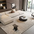 Modern Minimalist Living Room With Beige L shaped Sofa And Round Black Coffee Table