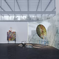 Modern Art Exhibition Space Featuring Large Circular Artwork Colorful Painting Sculptures And Metal Grid Ceiling