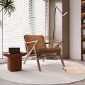 Modern Brown Leisure Chair With Wooden Frame Side Table And Potted Plant Near Floor Lamp And Bookshelf