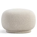 Cozy Beige Ottoman With Soft Gray Blanket Draped On Top
