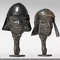 Antique Medieval Helmets With Ornate Metal Designs Displayed On Head Mannequins