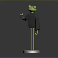 Green Frog Sculpture with Black Clothing Red Eyes and Thumbs Up Gesture on Silver Base