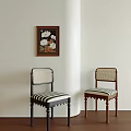 Stylish Dining Chairs With Black Brown Frames Woven Backs Striped Cushions And Wall Flower Painting