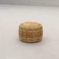 Round Woven Straw Stool with Striped Brown Beige Texture on Neutral Gray Floor