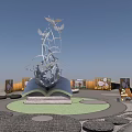 Open Book Shaped Landscape Sculpture With Metal Birds And Green Park Setting