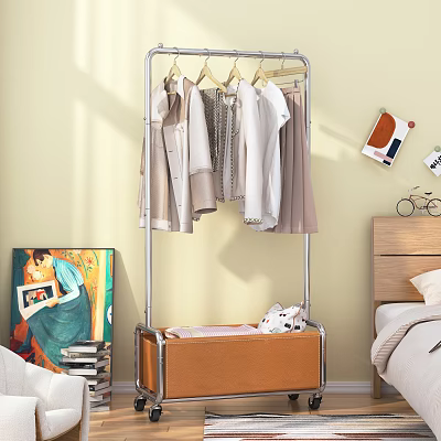 Metal Clothes Rack With Hanging Shirts Coats And Wooden Cabinet In Bedroom With Wall Art And Books 3d model