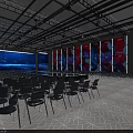 Spacious Indoor Venue With Rows of Chairs Large LED Screen and Central Platform