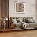 Plush Beige Double Sofa with Cushions Throw Blanket Metal Table Lamp and Geometric Artwork Near Wooden Striped Wall