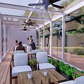 Spacious Glass Sunroom On Wooden Deck With Outdoor Tables Chairs And Green Trees