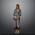 Woman in Blue and White Striped Dress with Crossed Hands Wearing Orange Shoes Gray Background