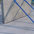 Concrete Slab Structure with Blue Support Poles and Exposed Steel Bars at Construction Site