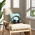 Linen Armchair with Turquoise Cushion Black Headphones and Green Plants Near Window