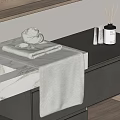 Folded Gray Towel on Bathroom Countertop with Aromatherapy Sticks and Decorative Bottles